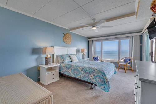 a bedroom with a bed and a view of the ocean at Salty Sands in Ocean City