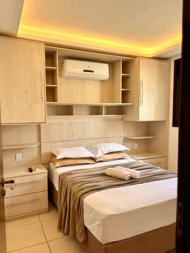 a bedroom with two beds and a air conditioner at Hotel Natal Ponta Negra Sun in Natal