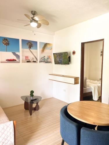 a living room with a table and a couch at Zand Pointe Suites in General Luna