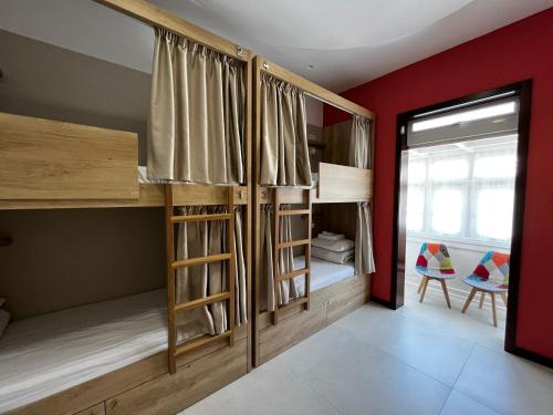a room with two bunk beds and a window at Central Hostel Malta in Birkirkara