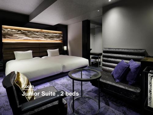 a bedroom with a king sized bed and a couch at Mitsui Garden Hotel Nihonbashi Premier in Tokyo