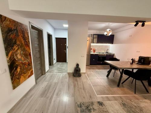 a kitchen and dining room with a table in a room at Panoramic Self Check-in Underground Parking in Iaşi