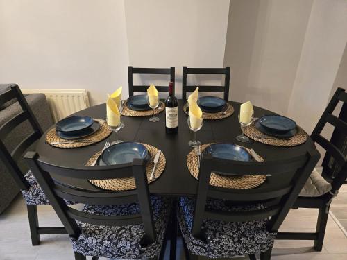 a dining room table with a black table and chairs at Dreams and Homes in Dublin- Entire home in Hartstown