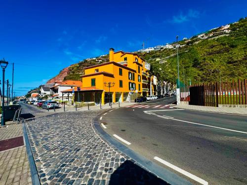a yellow building on the side of a street at VALE MAR Guest in Ribeira Brava