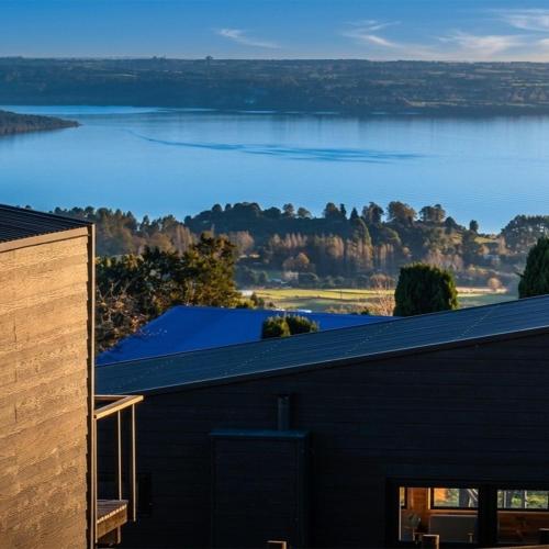 a house with a view of the water at Volcano Suites in Puyehue
