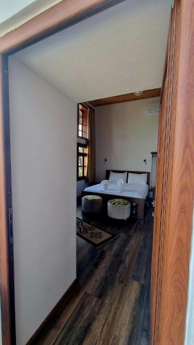a bedroom with a bed and a large mirror at Sorlesa in Gjirokastër