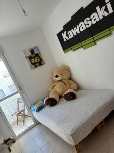 a teddy bear sitting on a bed in a room at Résidence Calme Fnideq in Fnidek