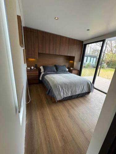 a bedroom with a bed and a large window at MODULAR NUEVA l in San Luis