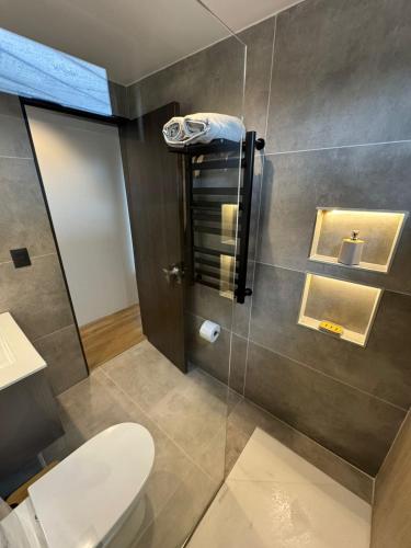 a bathroom with a toilet and a glass wall at MODULAR NUEVA l in San Luis