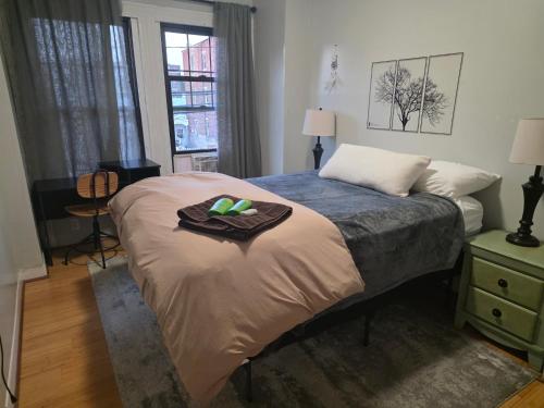 a bedroom with a bed with a tray on it at Vintage Home Vibe in Jersey City