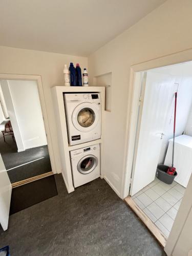 a laundry room with a washer and dryer at Central Large Double Room with free parking in Aalborg