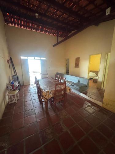 a room with a table and chairs and a bedroom at Casa de Praia do Morro Branco in Beberibe
