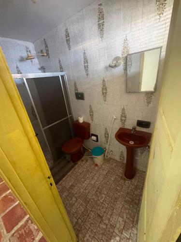a bathroom with a shower and a toilet and a sink at Casa de Praia do Morro Branco in Beberibe