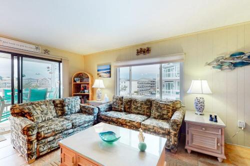 a living room with a couch and a table at Surfs Up 301 in Ocean City