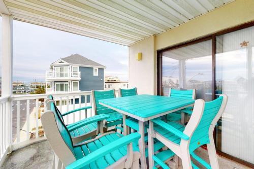 a blue table and chairs on a balcony at Surfs Up 301 in Ocean City