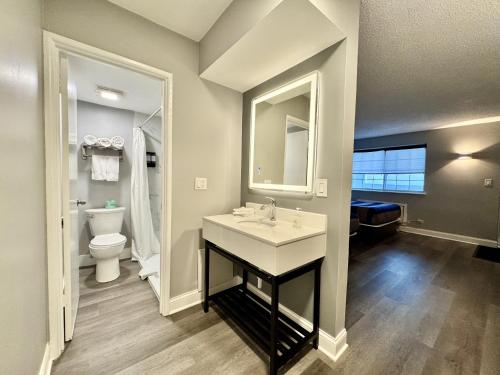 a bathroom with a sink and a toilet at O'Hare Inn & Suites in Schiller Park