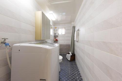 a small bathroom with a toilet and a sink at 옥상달빛 게스트하우스 in Seoul