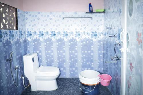 a bathroom with a toilet and a shower at Peak Homestay in Kalasa