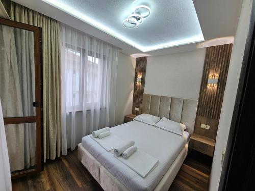 a bedroom with a large white bed with white sheets at Villa Diana Self check-in in Kiten
