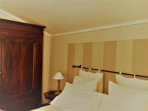 a hotel room with a bed with white pillows at Agriturismo Nonna Du in Gavi