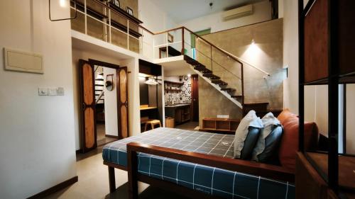 a room with a staircase and a couch in it at Cozy & Spacious 2BR Private House in Siem Reap