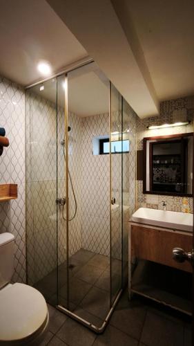 a bathroom with a shower and a toilet and a sink at Cozy & Spacious 2BR Private House in Siem Reap
