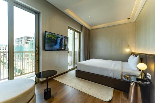 a hotel room with a bed and a large window at Villa 5 phòng ngủ cao cấp in Dong Hoi