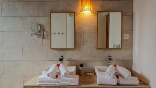 a bathroom with two sinks and towels on a counter at Maeva Beach in Sainte Marie