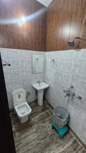 a bathroom with a toilet and a bidet and a sink at Sukoon guest house in Jammu