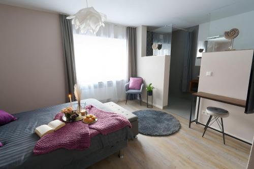 a bedroom with a bed and a table with candles on it at Ferienwohnung Hummel in Gammertingen