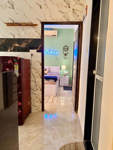 a hallway with a door to a room with a bedroom at Sugar Waves in Navi Mumbai