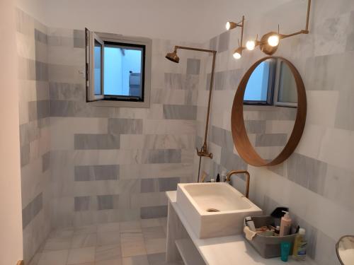 a bathroom with a sink and a mirror at I have a big dream in Agia Pelagia