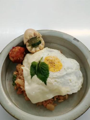 a plate of food with eggs on top of pasta at Ernie MyeongDon'g Sation 1Min, Anytime Check In in Seoul