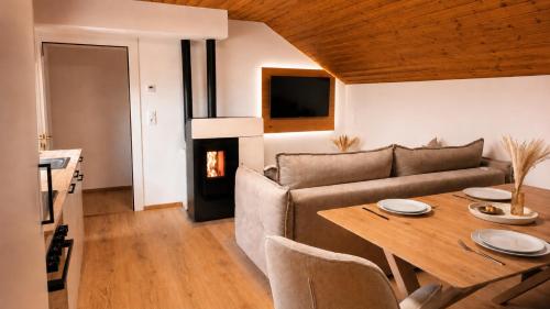 a living room with a couch and a table at Michelis Cottage - Achensee in Pertisau