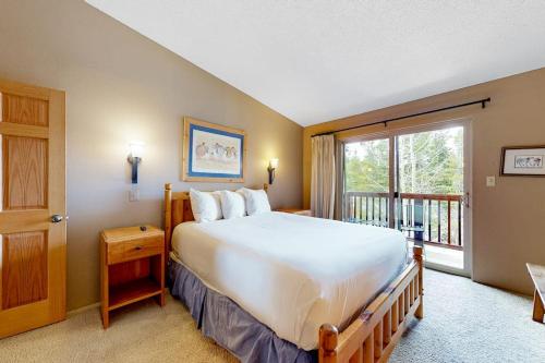a bedroom with a large bed and a window at Pine Ridge Condos in Breckenridge