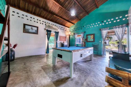 a room with a ping pong table in it at Villa Lokobe in Hell-Ville