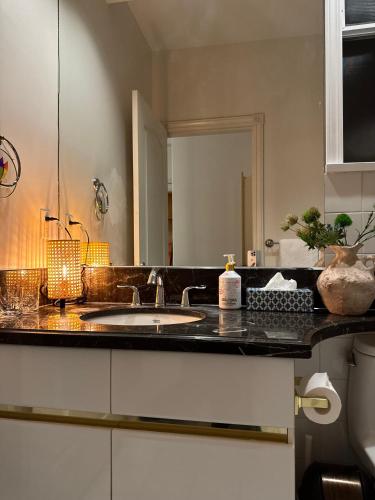 a bathroom counter with a sink and a mirror at sweet home in Richmond
