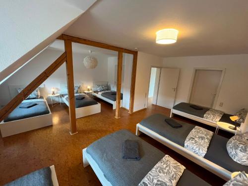 an attic room with three beds and a mirror at Süße Marie 18 - Coffee for free - in Karlsruhe