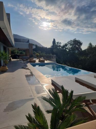 a swimming pool with a view of the mountains at Villa Westwood in Parga