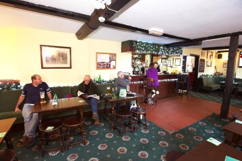 a group of people sitting at tables in a restaurant at The Black Swan Inn in Leominster