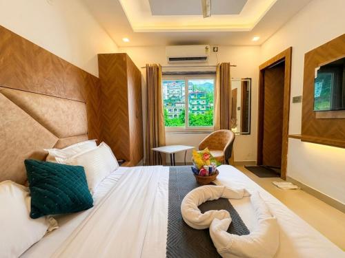 a bedroom with a large bed with a large headboard at Hotel Mahadev Tapovan in Rishīkesh