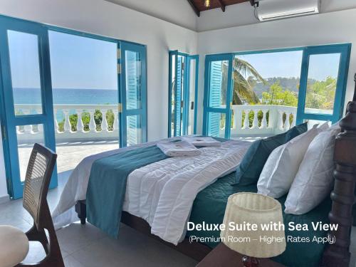 a bedroom with a bed with a view of the ocean at Seashore Mirissa in Mirissa