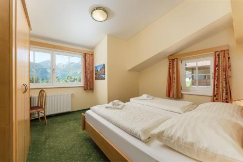 a bedroom with two beds and a window at Apparthotel Bliem in Schladming
