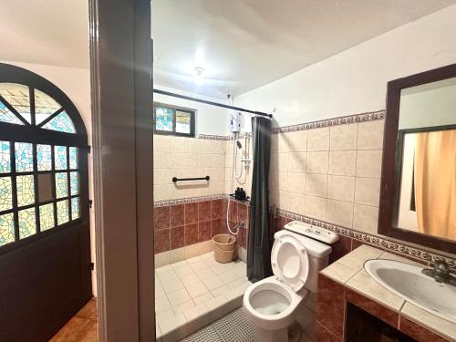 a bathroom with a toilet and a sink at MC Mountain Home in Tagaytay