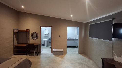 a living room with a couch and a tv at GROOTVALLEI SELF CATERING Units in Mahikeng