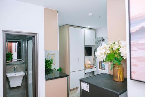 a kitchen with a vase of flowers on a counter at Auri House in Hanoi