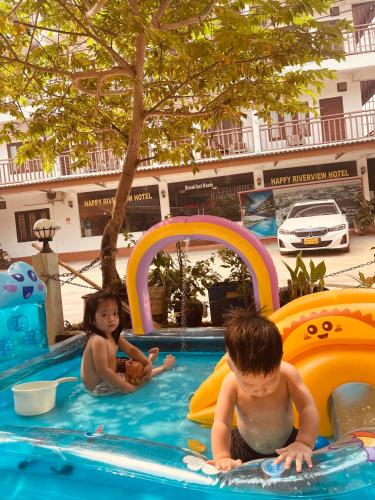 two children playing in a pool at a resort at Vangvieng dream house in Vang Vieng
