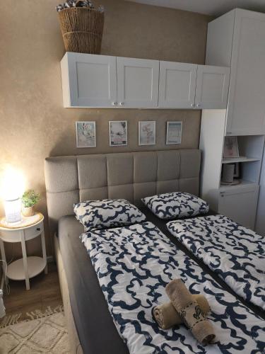 a bedroom with a bed with a teddy bear on it at Blue harmony 1 Malinska in Malinska