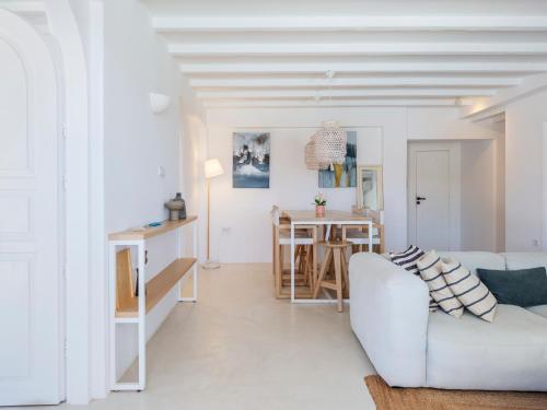 a white living room with a white couch and a table at myMykonos Villa I in Platis Gialos