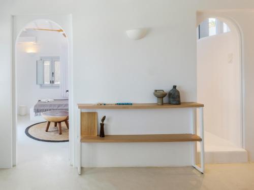a white room with a table and a chair at myMykonos Villa I in Platis Gialos